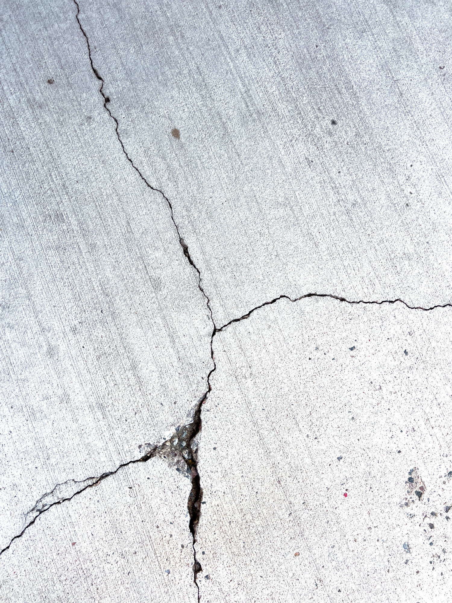 Close-Up of a Cracked Concrete Surface Close-Up of a Cracked Concrete Surface