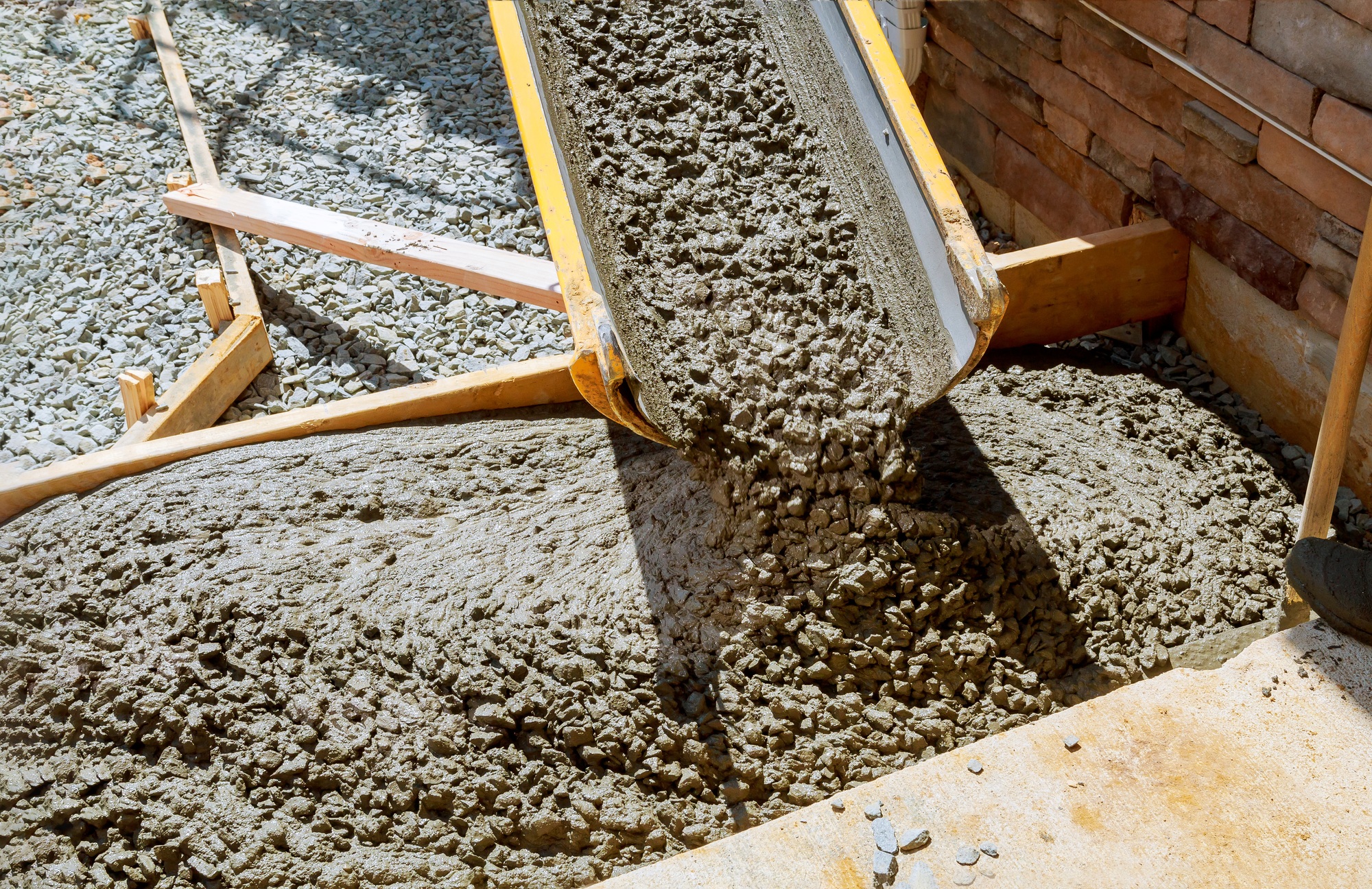 Pouring cement during paving concrete pavement near the driveway Pouring cement during paving concrete pavement near the driveway